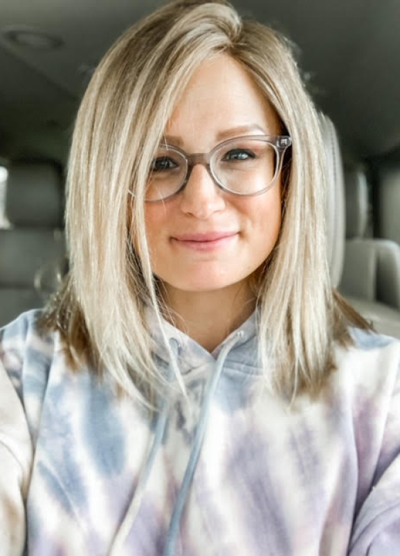 Woman wearing a blond wig made from her own hair